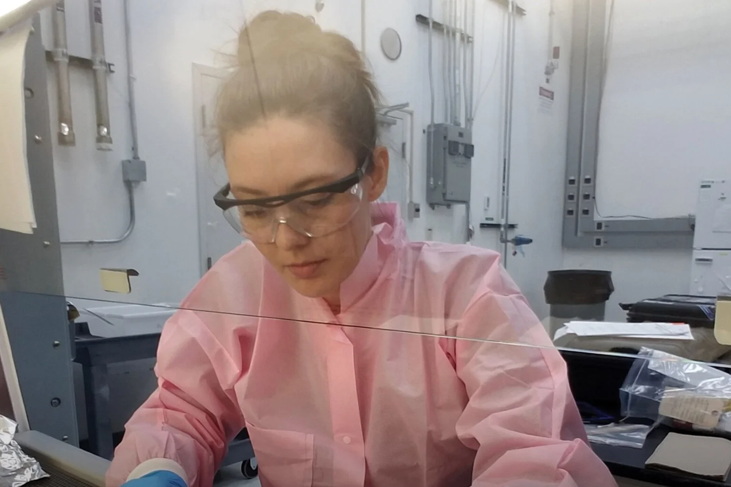 Scientist working in a lab with equipment.