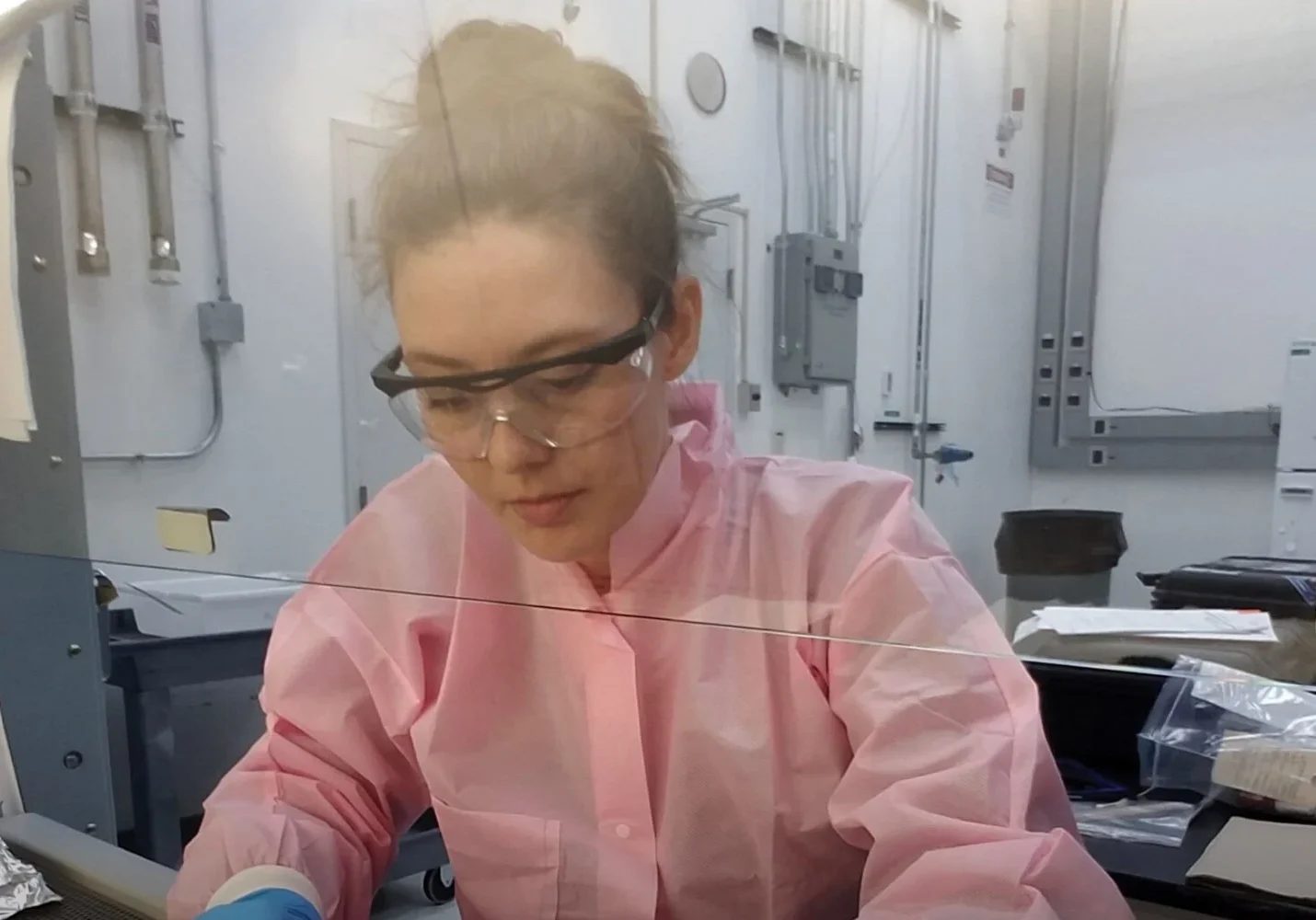 Scientist working in a lab with equipment.